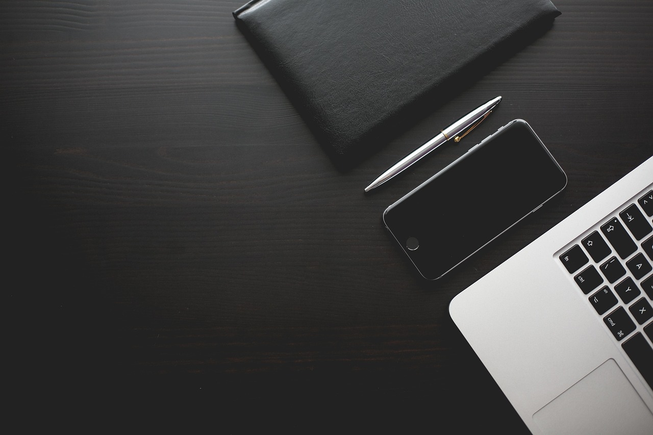 a laptop and mobile phone on a table Advertising and Marketing Agency in Dubai